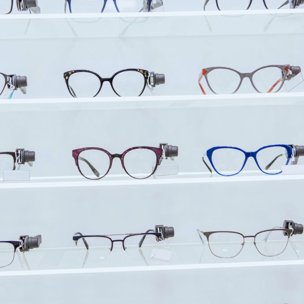 white shelves with stylish eyeglasses in optica